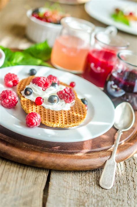 Belgian Waffles With Whipped Cream And Fresh Berries Stock Photo