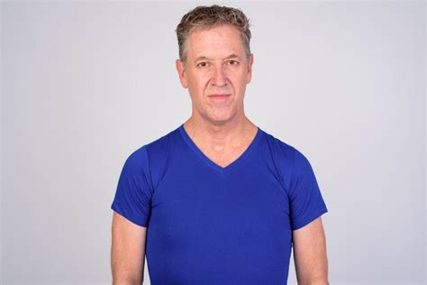 Premium Photo Mature Man Wearing Blue Shirt Against White Background