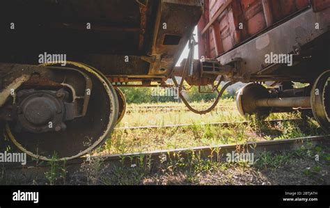 Two Old Rusty Train Cars Connected With Rusty Coupler On Railway Stock