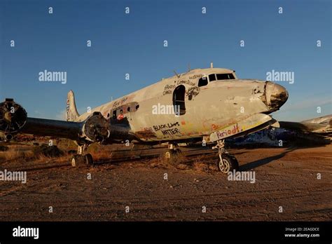 An Abandoned Airplane Covered In Graffiti In The Desert Wilderness