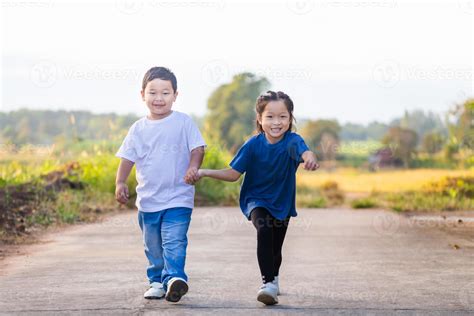 happy playful children running outdoors  spring park asian kids