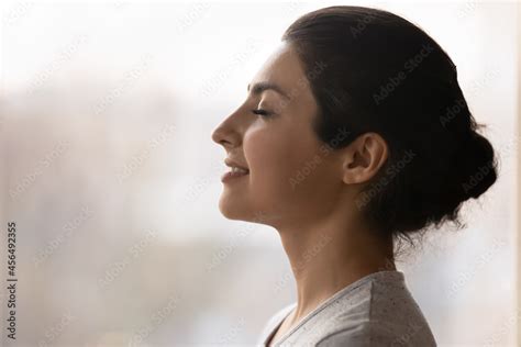 Meditation. Side profile shot of happy serene young indian female face ...