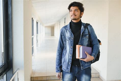 Portrait Of Indian College Boy Holding Books Stock Photo Adobe Stock