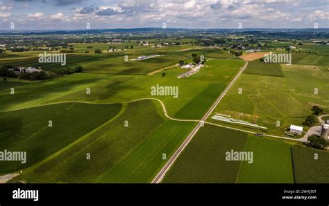 Expansive Aerial View Of Rolling Green Agricultural Fields Farm