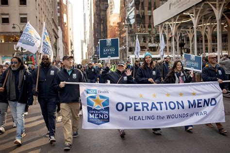 Photo | A group of people marching in New York’s Veterans Day parade ...