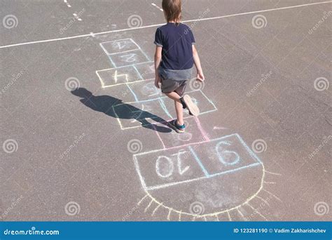 Boy Jumps Playing Hopscotch In The Street Stock Photo Image Of