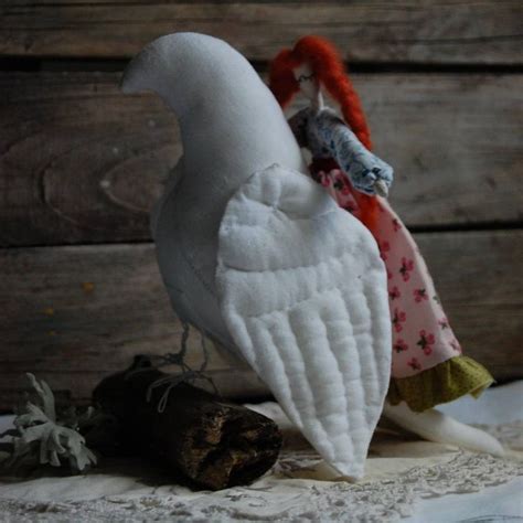 Two White Stuffed Birds Sitting Next To Each Other