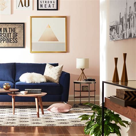 Blush Wall Color With A Navy Blue Couch Giving The Look A Perfect Calm Modern Living Room Style