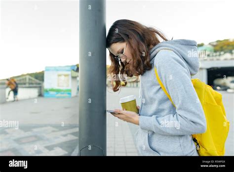 Smart Focused Girl Is Distracted By Mobile Phone Girl Reading