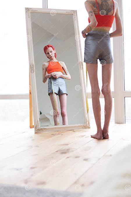 Extremely Skinny And Slim Anorexic Woman Looking Into Mirror Stock