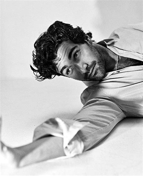 A Black And White Photo Of A Man Laying On The Floor With His Legs Crossed