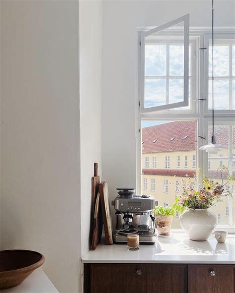 A Kitchen Counter With Pots And Pans On It Next To A Window That Looks