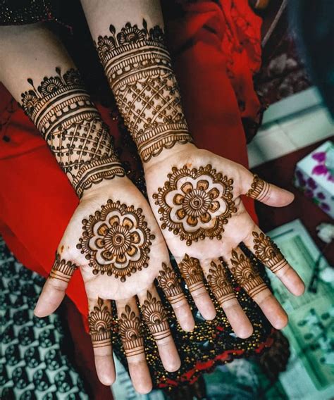 Two Hands With Henna Designs On Them