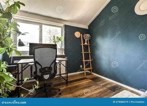 A Home Office With A Chair And A Blue Wall Stock Image Image Of Room