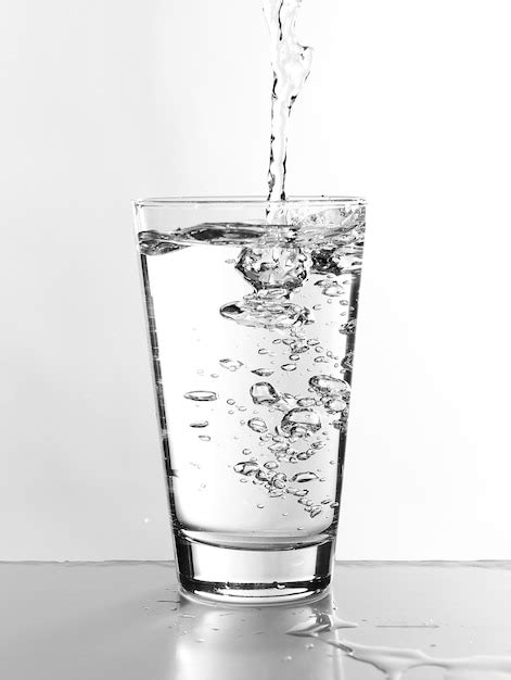 Premium Photo Water Pouring In Glass Isolated On White