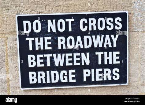 "Do not cross the roadway between the bridge piers" sign Stock Photo ...