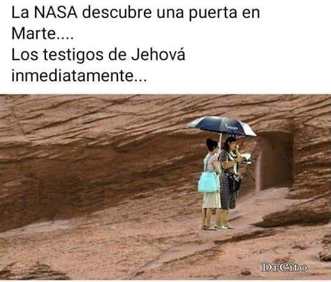 Two People Standing Under An Umbrella In The Rain