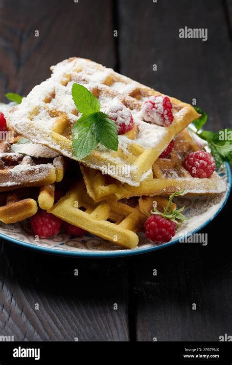 Stack Of Baked Belgian Waffles With Ripe Red Raspberry Sprinkled With