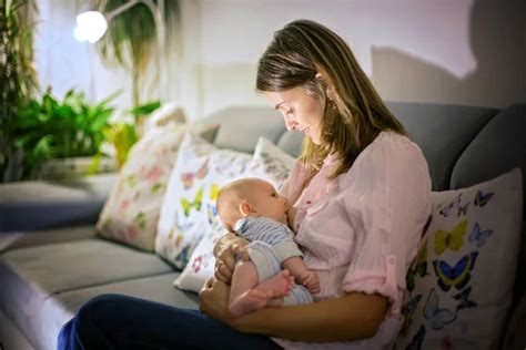 Young Mother Breastfeeding Her Newborn Baby Boy Stock Photo By ©t