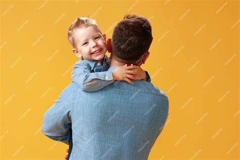 Premium Photo Happy Fathers Day Cute Dad And Son Hugging On Yellow