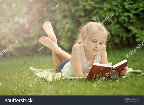 Young Girl Lying On Grass Reading Stock Photo 624860489 | Shutterstock