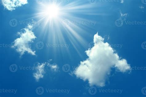 A blue sky with sun and clouds background. Shining sun on blue sky with clouds.Sunny sky ...