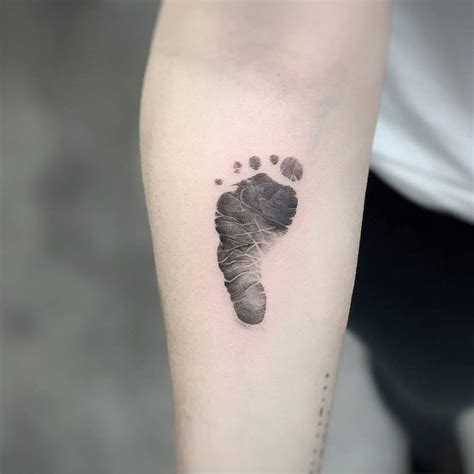 Micro-realistic baby footprint tattooed on the inner