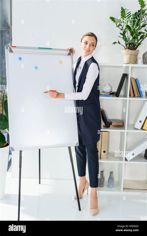 Businesswoman Writing On Whiteboard Stock Photo Alamy