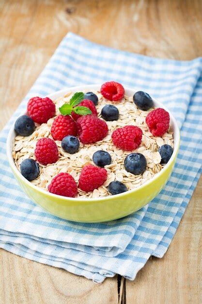 Gachas de avena con frutos rojos frambuesas y arándanos Foto Premium