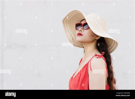 Fashionable Woman Wearing Hat And Sunglasses Against White Background