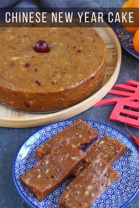 Chinese New Year Cake With Oranges On The Side And Plates Next To Each