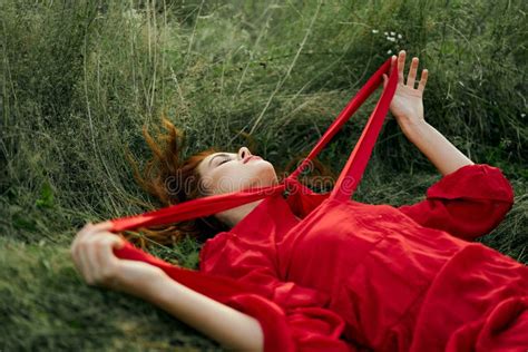 Woman In Red Dress Lying On The Grass Fresh Air Nature Romance Stock