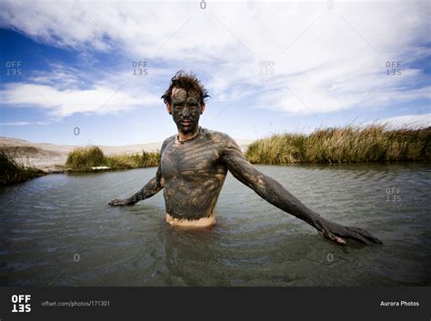 A Man Covered In Mud Baths In A Hot Springs Tecopa California Usa