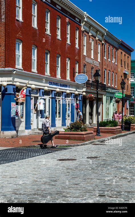 People Strolling In Front Of Shops And Stores In Historic Buildings