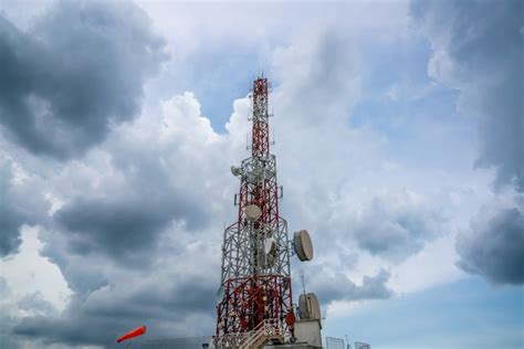 Premium Photo | Large telecommunication tower against sky and clouds in background