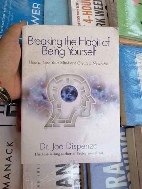 The Book Breaking The Habit Of Being Yourself By Dr Joe Dispenza Is Held Up