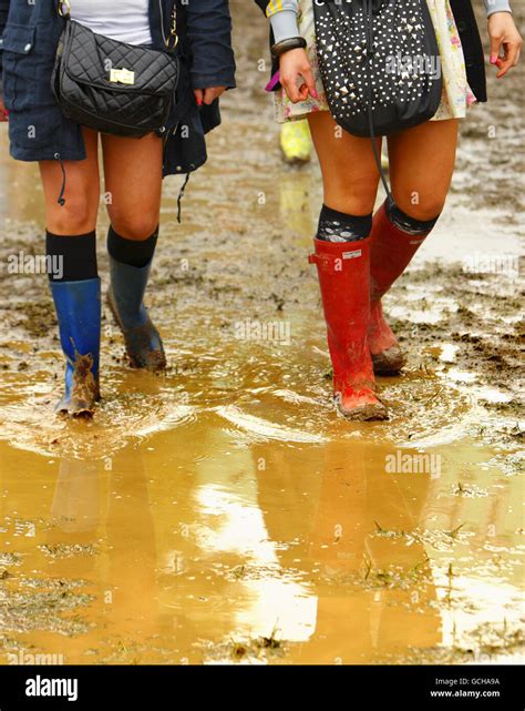 Music Lovers Walk Through Muddy Puddles As They Arrive At Seaclose Park