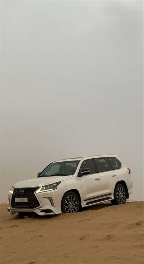 White Lexus SUV in Sandy Desert