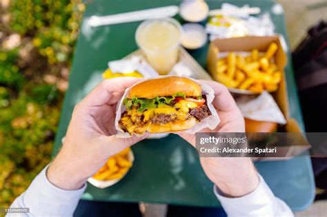 Man Eating Cheeseburger Personal Perspective View High Res Stock Photo