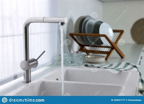 Stream Of Water Flowing From Tap In Kitchen Space For Text Stock Image