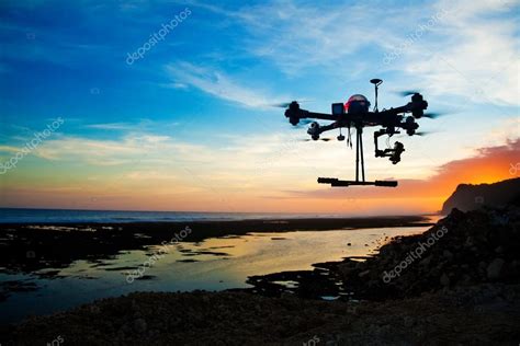 Drone silhouette against sunset sky — Stock Photo © apid #127990678