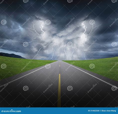 Rainstorm Clouds and Lightning with Asphalt Road and Grass Stock Photo ...