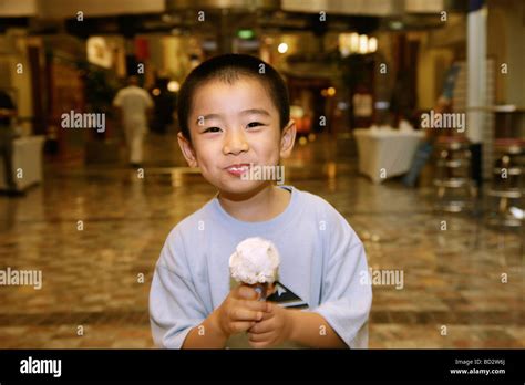 Chinese child eating ice cream Stock Photo - Alamy