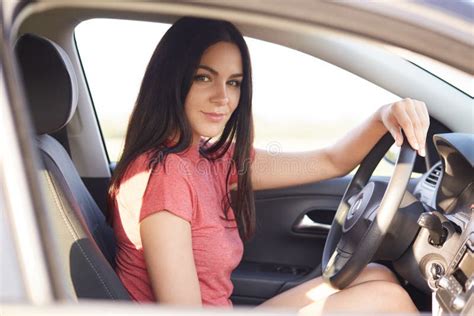 Young Gorgeous Brunette Lady Drives Car Alone Looks Confidently At