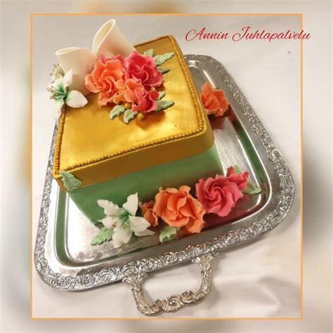 There Is A Cake With Flowers On The Top Of It And An Elegant Silver Platter