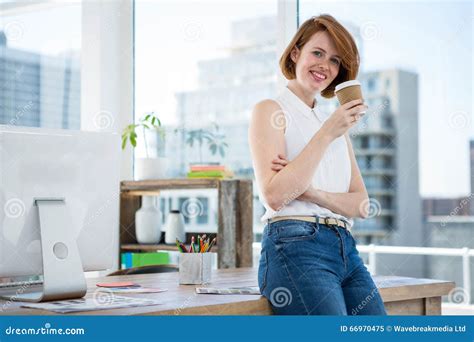 Smiling Hipster Business Woman Drinking Coffee In Her Office Stock