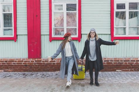 Premium Photo Two Cheerful Funny Tourist Women Smiling And Fool