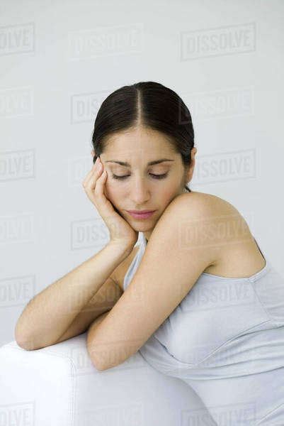 Woman Leaning On Elbow Looking Down Stock Photo Dissolve