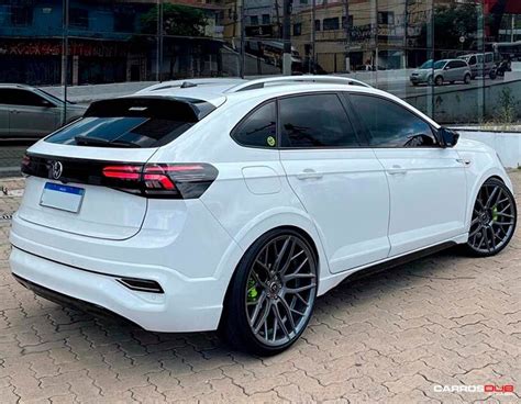 A White Car Parked In Front Of A Building