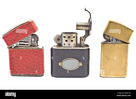 Three vintage cigarette lighters isolated on white Stock Photo - Alamy